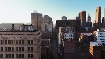 Aerial footage of downtown Cincinnati, Ohio showing big skyscrapers and the sun in the morning.