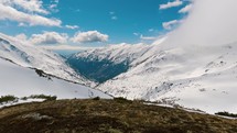 Panorama of snowy alps mountains valley in beautiful sunny day in early spring season, peaceful outdoor background
