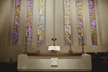 An altar with stain-glassed windows