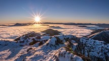 Peaceful morning sunrise in frozen snowy mountains nature landscape in cold winter time lapse
