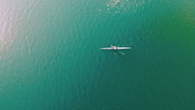 Wonderful aerial footage of men swimming in kayak on blue river water