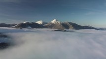 Fly above foggy clouds in winter mountains. Hyper lapse
