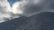 Dramatic clouds over winter snowy mountains
