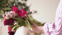 a woman arranging flowers for mother's day 