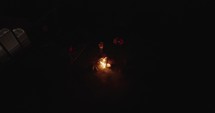 People standing around a campfire