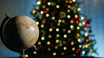 Earth rotating under Christmas tree lights background 