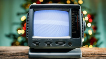 Old static tv with Christmas background 