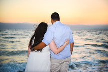 couple standing together on a beach 