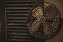 an old rusty fan and shutters 