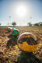 soccer balls in mud