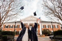 graduates tossing their graduation caps 
