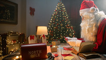 Santa Claus working under the Christmas tree 