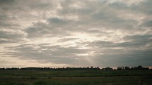Meadow sky time-lapse video, fast moving clouds