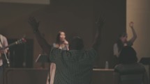 hands raised at a worship service listening to worship music 