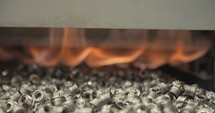 Metal parts during heat and coating process in a production facility