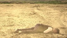 a man collapsing in a desert 
