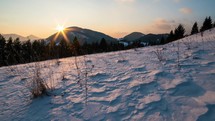 Timelapse of sunset evening in snowy winter country.
