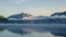 Foggy morning over mountain lake Time lapse
