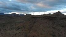 Aerial pullback of wind turbines on a desert mesa