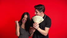 Excited couple holding money