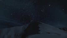 Dark starry night sky with stars over snowy winter mountains Astronomy Time-lapse
