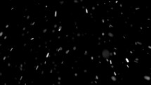 Snow falling over black background.