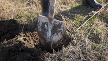 Man Using Shovel To Dig A Hole For Planting Tree - High Angle, Close Up	
