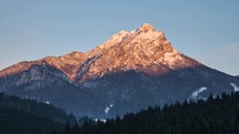 Sunset over alpine peak in winter Time lapse
