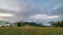 Magic foggy morning with clouds rolling over beautiful landscape at sunrise in autumn mountains. Time lapse timelapse
