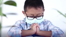 little boy with praying hands 