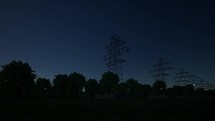 Electricity transmission towers with glowing wires electricity and energy facility industry high voltage post