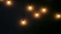 vintage blinking hanging lightbulbs on a wall