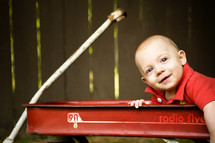 infant boy sitting in a wagon