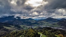 Aerial view of Dramatic clouds moving fast over autumn countryside landscape in Europe alpine nature, Hyper lapse
