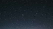 Stars in starry night sky fast time lapse in dark blue night Astronomy background night to day
