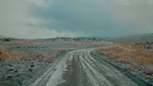 dirt road through a barren landscape 