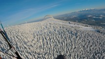 Paragliding flying freedom in winter wonderland
