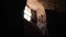 Light coming in an obscure room through a broken window