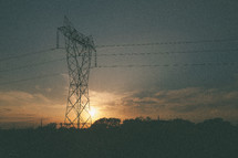 sun setting behind Power lines 