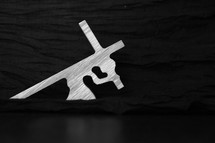 wood crucifixion sculpture on black background 