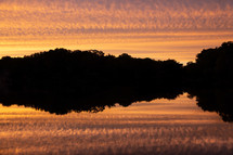 reflection of clouds on water at sunset 