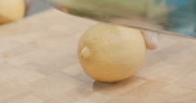 Slow motion shot of lemon slicing in an outdoor kitchen