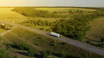 Aerial of a semi truck traveling. Aerial View of White Semi Truck with Cargo Trailer.