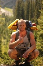 a man hiking with thumbs up 