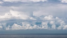 Heavy stormy clouds forming over blue ocean before storm Time lapse
