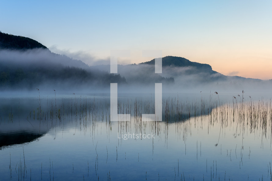 fog over a lake at sunrise 