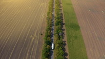 Aerial of a semi truck traveling. Aerial View of White Semi Truck with Cargo Trailer.