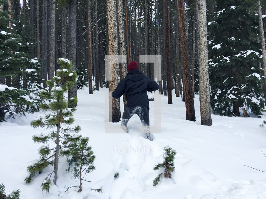 a man walking in deep snow