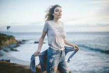 woman wearing a John 3:16 t-shirt on a beach 