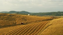 Farming Machines Shaping A Wheat Field Landscape 